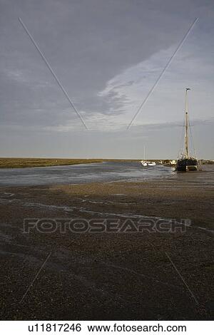 Stock Photograph - UK Norfolk sailboat in bay. Fotosearch