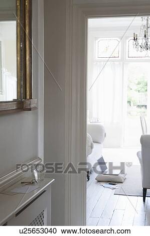 Stock Image - View through doorframe from hallway to living room. Fotosearch