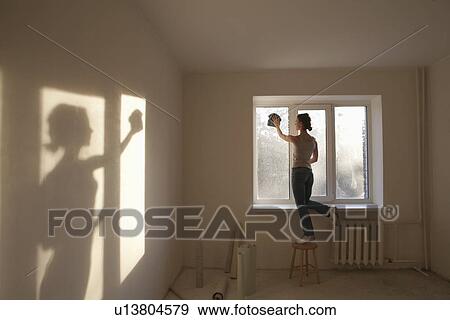 Woman cleaning windows in new apartment View Large Photo Image Stock Photo - Woman cleaning windows in new apartment. Fotosearch