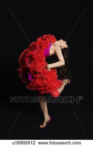 Woman dancing against black background View Large Photo Image Stock Image - Woman dancing against black background. Fotosearch