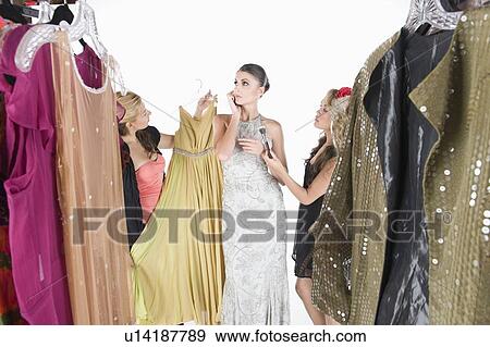 Woman stands ignoring wardrobe assistants View Large Photo Image Stock Photo - Woman stands ignoring wardrobe assistants. Fotosearch