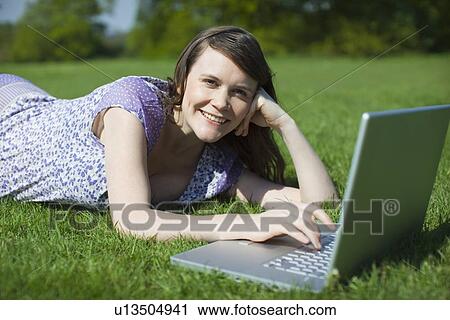 Woman using laptop outside View Large Photo Image Stock Image - Woman using laptop outside. Fotosearch