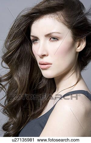 Woman with long brown wavy hair portrait View Large Photo Image Stock Image - Woman with long brown wavy hair portrait. Fotosearch