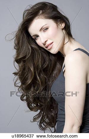 Woman with long brown wavy hair portrait View Large Photo Image Stock Photo - Woman with long brown wavy hair portrait. Fotosearch