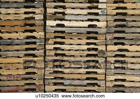 Wooden pallets stacked in distribution warehouse View Large Photo Image Stock Photography - Wooden pallets stacked in distribution warehouse. Fotosearch