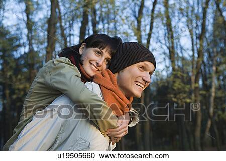 Young couple embracing in forest View Large Photo Image Stock Image - Young couple embracing in forest. Fotosearch