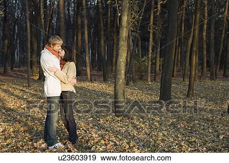 Young couple embracing in forest View Large Photo Image Stock Photo - Young couple embracing in forest. Fotosearch