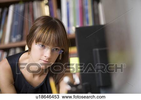 Young designer leans forward working at computer screen View Large Photo Image Stock Image - Young designer leans forward working at computer screen. Fotosearch