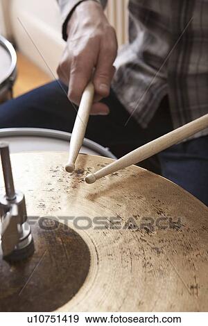 Stock Photo - Young man plays cymbals. Fotosearch