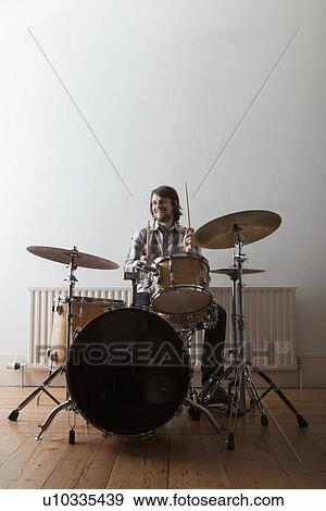 Young man plays drum set View Large Photo Image Stock Photo - Young man plays drum set. Fotosearch