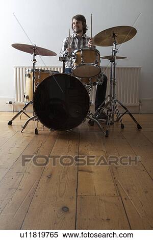Stock Photography - Young man plays drum set. Fotosearch