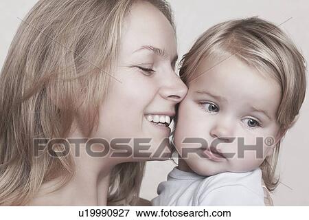 Stock Photo - Young mother is overjoyed with her toddler. Fotosearch