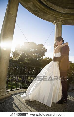 Young newlywed couple embracing View Large Photo Image Stock Photo - Young newlywed couple embracing. Fotosearch