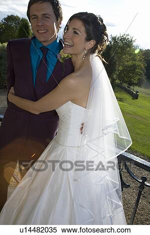 Young newlywed couple embracing View Large Photo Image Stock Photography - Young newlywed couple embracing. Fotosearch