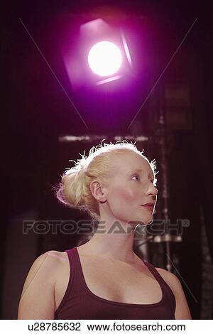 Stock Image - Young woman on stage close up. Fotosearch
