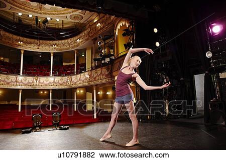 Stock Image - Young woman on stage. Fotosearch