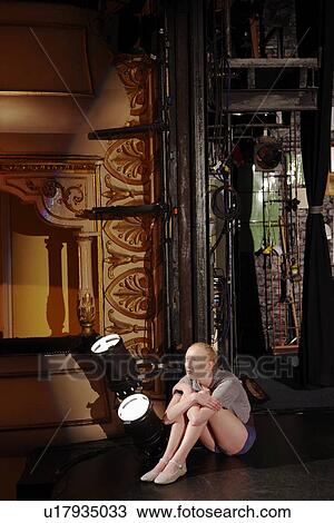 Stock Image - Young woman on stage. Fotosearch