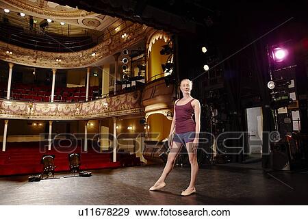 Stock Photo - Young woman on stage. Fotosearch