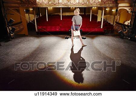 Stock Photo - Young woman on stage. Fotosearch