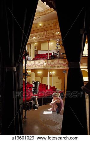 Young woman on stage view through stage curtain View Large Photo Image Stock Photo - Young woman on stage view through stage curtain. Fotosearch