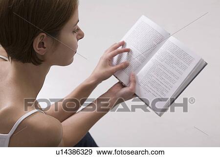 Young woman reading book View Large Photo Image Stock Photo - Young woman reading book. Fotosearch