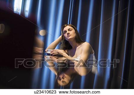 Young woman relaxing at bar View Large Photo Image Stock Image - Young woman relaxing at bar. Fotosearch