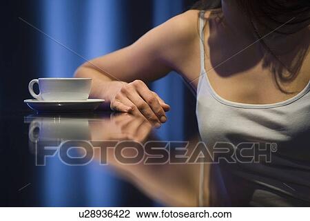 Young woman relaxing at bar View Large Photo Image Stock Image - Young woman relaxing at bar. Fotosearch