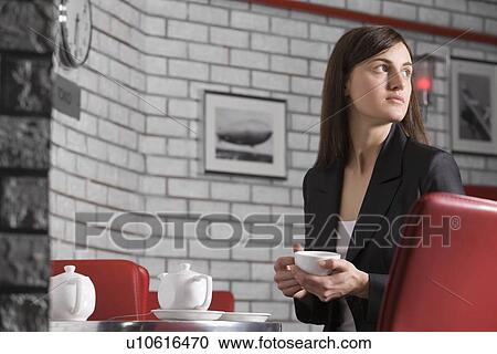 Young woman relaxing in cafe View Large Photo Image Stock Image - Young woman relaxing in cafe. Fotosearch