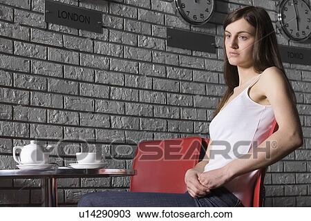 Young woman relaxing in cafe View Large Photo Image Stock Image - Young woman relaxing in cafe. Fotosearch
