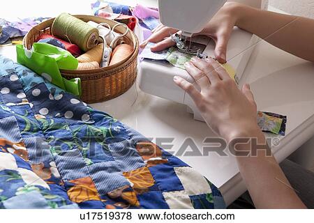 Young woman sits making patchwork at sewing machine View Large Photo Image Stock Photo - Young woman sits making patchwork at sewing machine. Fotosearch