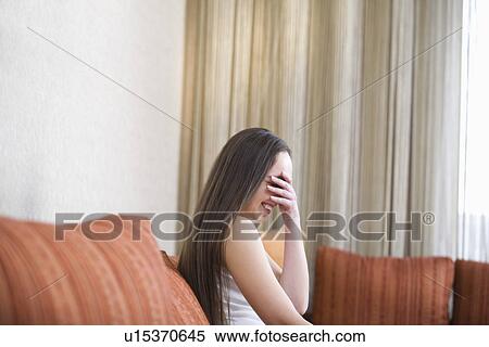 Young woman sitting on sofa and laughing portrait View Large Photo Image Stock Photography - Young woman sitting on sofa and laughing portrait. Fotosearch