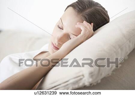 Young woman sleeping on sofa View Large Photo Image Stock Photo - Young woman sleeping on sofa. Fotosearch