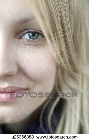 Stock Photo - Half face of smiling blonde woman with blue eyes. Fotosearch