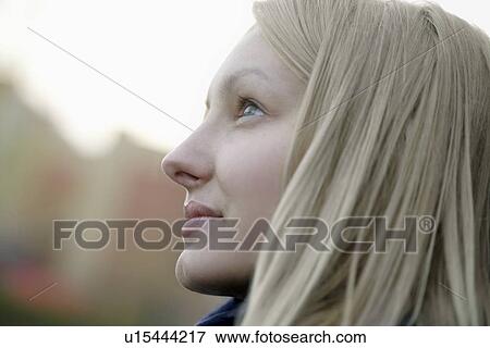 Profile of blonde woman outside looking up View Large Photo Image Stock Photo - Profile of blonde woman outside looking up. Fotosearch