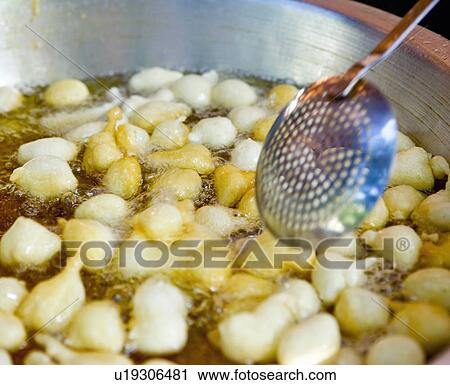 Stock Image - Traditional frying of dough balls, (Lokoumathes), Limassol, Cyprus. Fotosearch