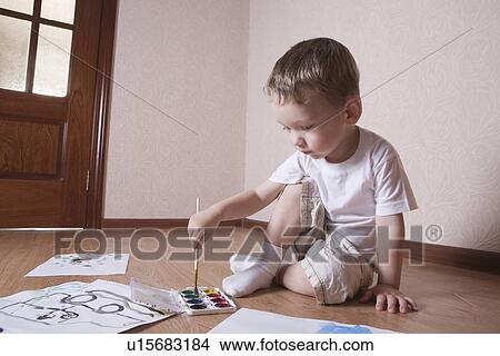 Picture - Young boy mixes paints. Fotosearch