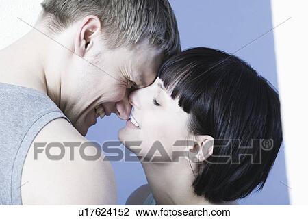 Stock Image - Young couple kissing. Fotosearch