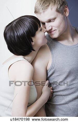 Young woman holds young man's arm, rubbing noses View Large Photo Image Stock Photo - Young woman holds young man's arm, rubbing noses. Fotosearch