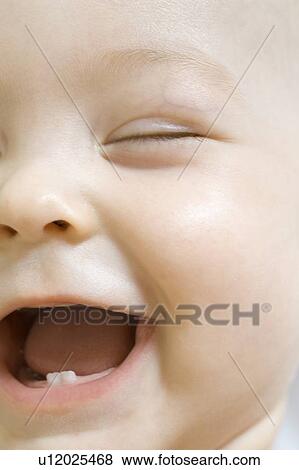 Stock Photo - Infant child laughing with milk teeth. Fotosearch