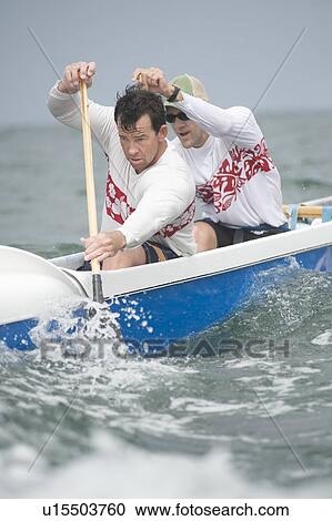Stock Image - Outrigger canoeing team of two. Fotosearch