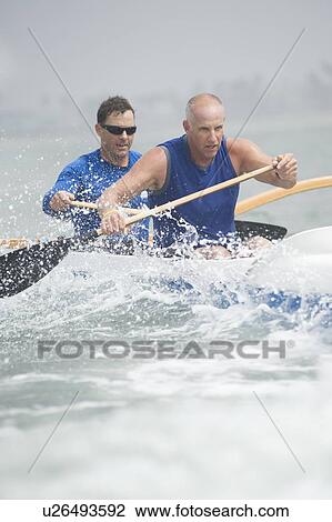 Outrigger canoeing team of two View Large Photo Image Stock Image - Outrigger canoeing team of two. Fotosearch