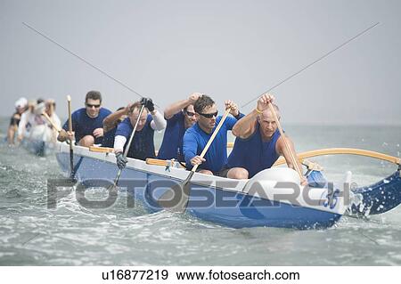Outrigger canoeing team on water View Large Photo Image Stock Photo - Outrigger canoeing team on water. Fotosearch