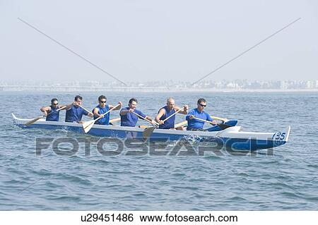 Outrigger canoeing team on water View Large Photo Image Stock Photograph - Outrigger canoeing team on water. Fotosearch