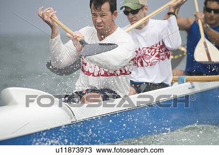 Outrigger canoeing team raise oars View Large Photo Image Stock Image - Outrigger canoeing team raise oars. Fotosearch