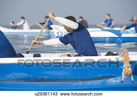 Stock Image - Outrigger canoeing teams compete. Fotosearch