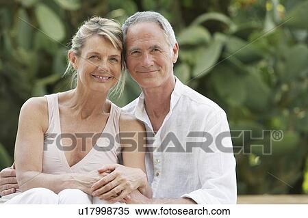 Stock Photography - Affectionate Senior Couple in Garden. Fotosearch
