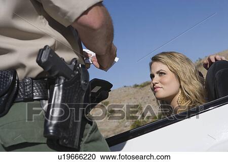 Armed police officer apprehends female driver View Large Photo Image Stock Image - Armed police officer apprehends female driver. Fotosearch