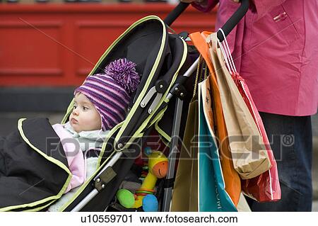 Baby sitting in stroller View Large Photo Image Stock Image - Baby sitting in stroller. Fotosearch