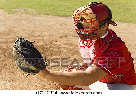 Baseball catcher crouching on baseball field View Large Photo Image Picture - Baseball catcher crouching on baseball field. Fotosearch