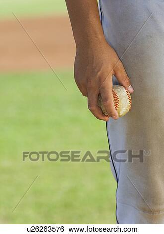 Baseball pitcher holding ball, (close-up), (mid section) View Large Photo Image Stock Photograph - Baseball pitcher holding ball, (close-up), (mid section). Fotosearch
